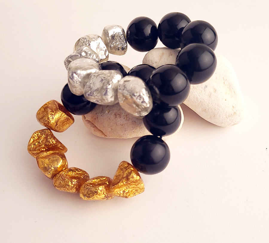 SET OF TWO BEADED HALF AND HALF  BRACELETS. BLACK/GOLD AND BLACK/SILVER COMBO